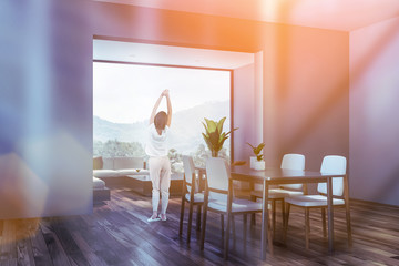 Woman in gray dining room corner