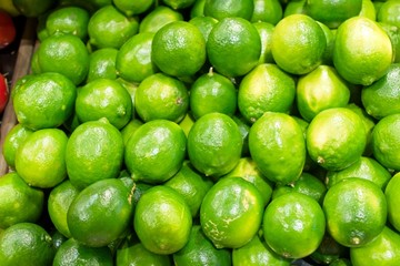 Fresh, tangy Limes on display at a grocery store.