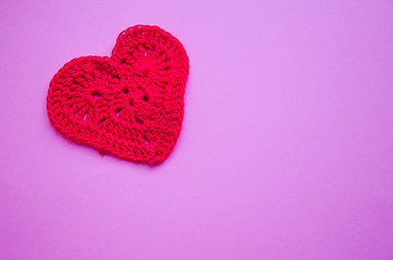 Knitted heart red on a pink purple background