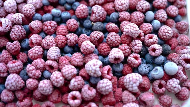 Background of frozen berries. Top view of raspberries and blueberries.