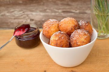 donuts and jam on a wooden background in nature