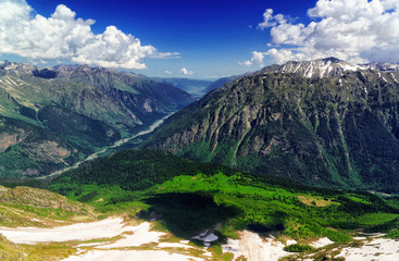 Naklejka na ściany i meble Mountain panorama in clouds. Caucasus, region Dombay.