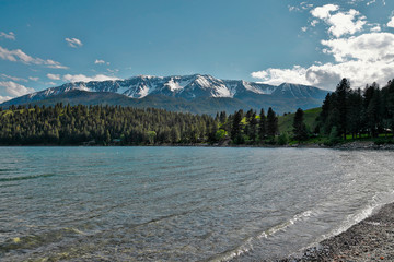 Sitting on the shore of the lake surrounded by mountains and beauty