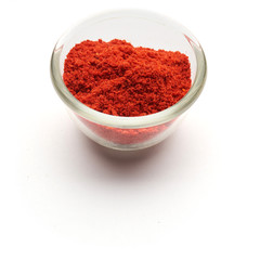 ground paprika isolated in  a glass plate