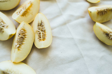 A group of brightly lit ripe melon halves.