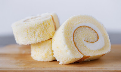 Vanilla roll cake on wood tray