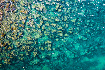 Aerial view of rocky stones in the sea