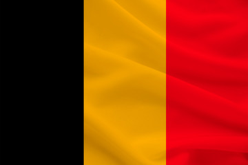 national flag of belgium on gentle silk with wind folds, travel concept, immigration, politics, copy space, close-up