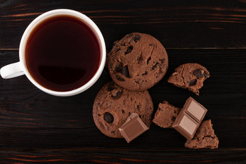 Chocolate cookies on wooden table. Homemade food on wooden background