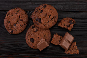 Chocolate cookies on wooden table. Homemade food on wooden background