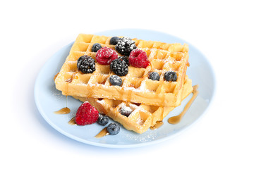Belgian waffles with berries on plate isolated on white background