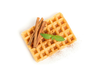 Belgian waffle with mint and cinnamon isolated on white background