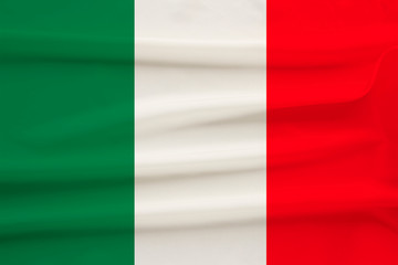 Obraz premium The national flag of the country of Italy on gentle silk with wind folds, travel concept, immigration, politics, copy space, close-up