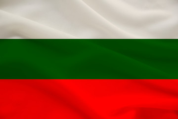Obraz premium national flag of Bulgaria on delicate silk with wind folds, travel concept, immigration, politics