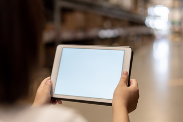 worker hand holding pad for check order pick time in smart factory warehouse