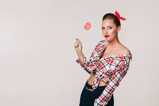 beautiful pin-up woman with lollipop. Copy space for text