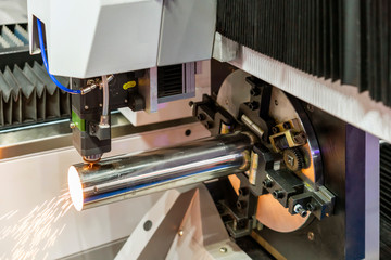 close up nozzle & pipe setting by clamp with automatic feed and rotate unit during cut by high precision cnc plasma laser cutting machine for engrave or perforate in factory or work shop