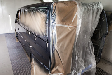 The car after the accident in the camera for car body repair is partially covered with paper and...