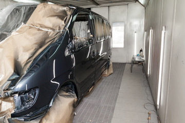 The car after the accident in the camera for car body repair is partially covered with paper and...