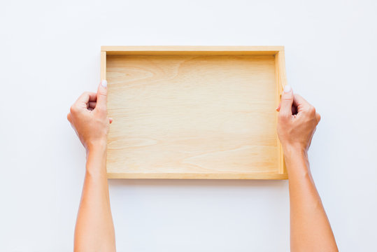 Female Hands Holding Wooden Empty Tray. Woman