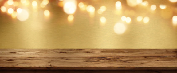 Golden metallic background with wooden table