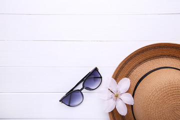 Vintage fabricate straw hat and sunglasses on white background.