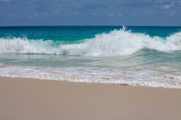 azure sea with waves on a sandy beach