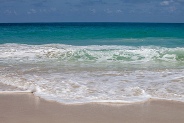Fototapeta na wymiar azure sea with waves on a sandy beach