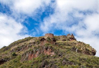 Inca ruins in Pisac archeological site and green peruvian Andes mountains, Sacred valley of the Incas, Peru