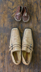 Father and son brown shoes on wooden background, fathers day