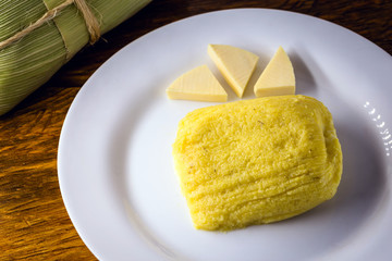pamonha, Brazilian sweet made from homemade cheese with corn. Open pissing ready for consumption. Concept of traditional Brazilian sweet, typical food of the months of June and July.