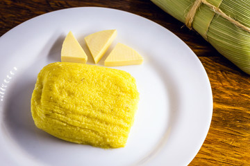 pamonha, Brazilian sweet made from homemade cheese with corn. Open pissing ready for consumption....