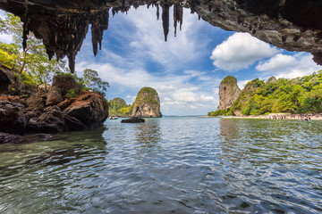 Seascape view from Phra Nang cave on blue sky with beautiful clouds, beach and tropical island in water at day time on Railay in Krabi in Thailand