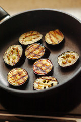 Chopped eggplant is fried in a skillet.
