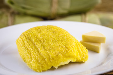 pamonha, Brazilian sweet made from homemade cheese with corn. Open pissing ready for consumption. Concept of traditional Brazilian sweet, typical food of the months of June and July.