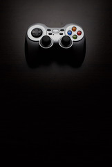 Wireless PC game controller (gamepad) on a black background