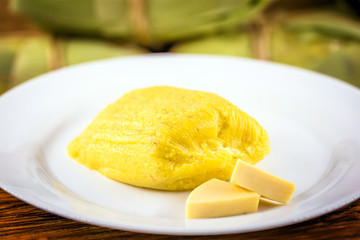 pamonha, Brazilian sweet made from homemade cheese with corn. Open pissing ready for consumption. Concept of traditional Brazilian sweet, typical food of the months of June and July.