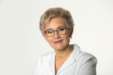 portrait of an adult woman with a short haircut wearing glasses in a white jacket on a white background