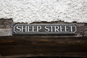 Sheep Street Road Sign on Stone Wall; England