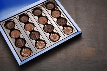 Box of chocolate on wood background with copy space