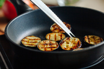 Eggplants are fried in a skillet. Close-up.