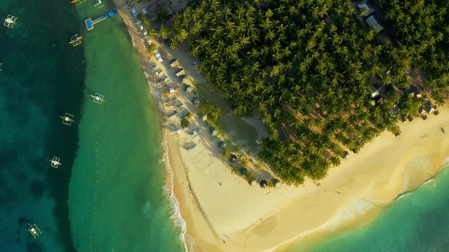 Aerial View of paradise white sand beach and azure sea on tropical Daku Island in Siargao, Philippines