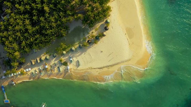 Aerial View of paradise white sand beach and azure sea on tropical Daku Island in Siargao, Philippines