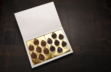 Box of chocolate on wood background with copy space