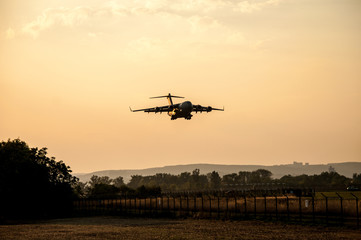 Fototapeta na wymiar Military cargo plane just before landing (Brno Airport, Czech Republic)