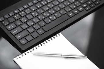 Office desk table with keyboard notepad and pen. 
