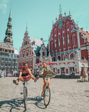 man and woman riding bicycle near building