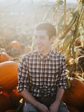 man sitting on pumpkin