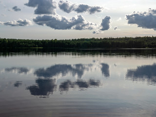clouds and forest reflecting in the still waters