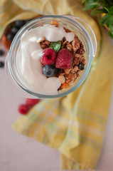 dry breakfast of granola and wild berries. Delivered in a glass plate